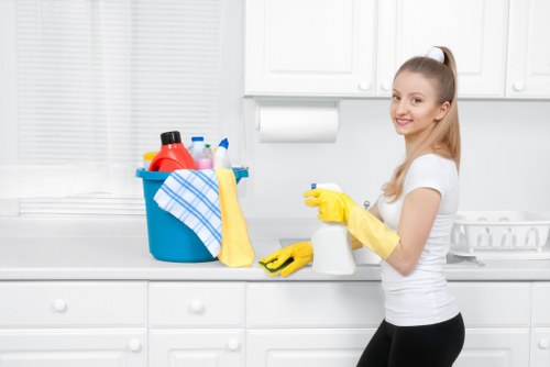 Cleaner maintaining a shared hallway in a W11 apartment building